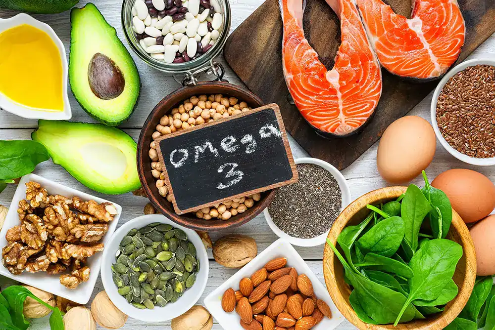 Healthy omega-3 rich foods including salmon, avocados, eggs, and nuts.
