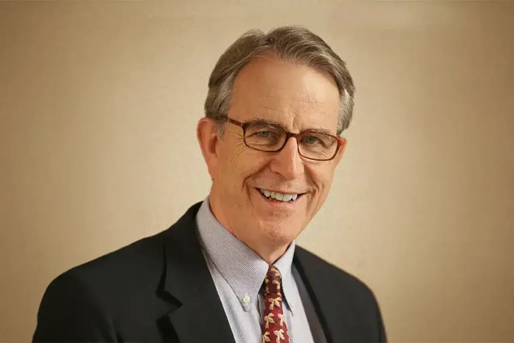 Professional portrait of Dr. Martin Moore-Ede in a suit and glasses.
